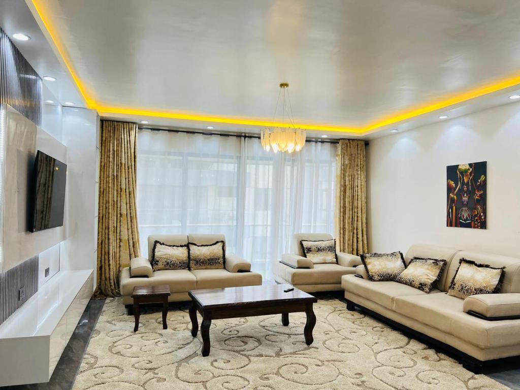 a living room with couches and a coffee table at Diamond Oark Residency in Gatunga