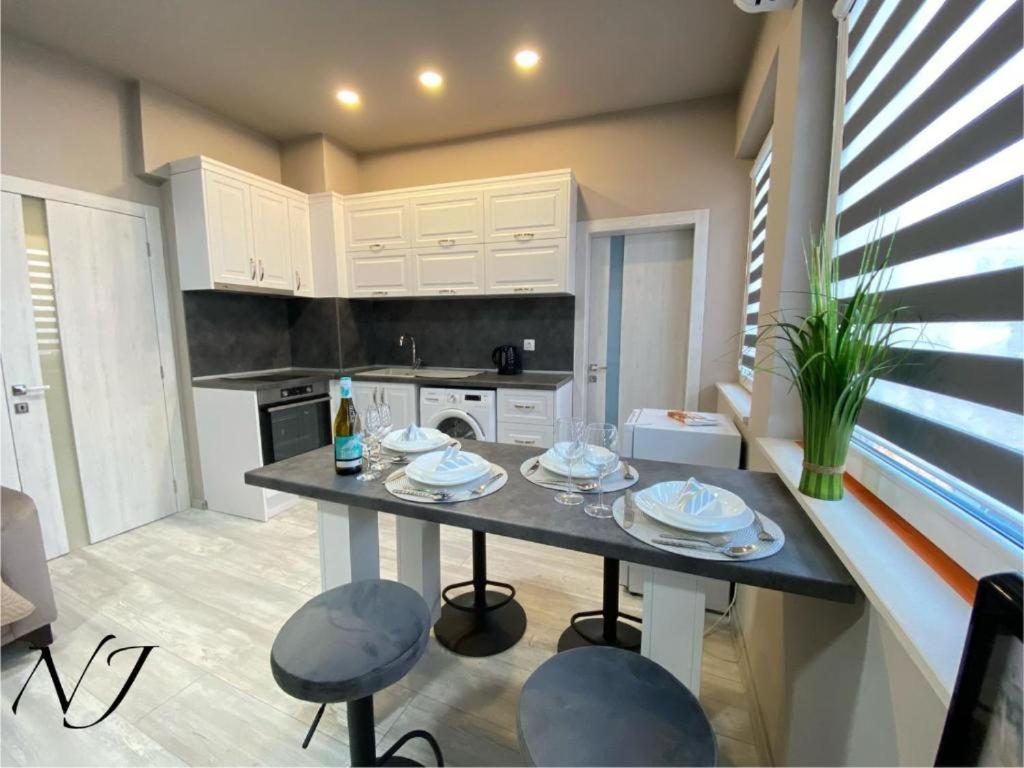 a kitchen with a table and chairs in a room at NJ Collection in Varna City