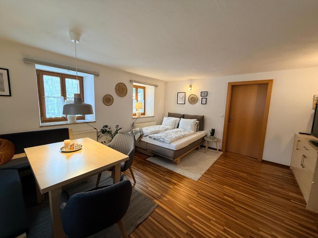 a living room with a couch and a table at Gemütliches Apartment im Krämerhaus in Annaberg , 1 Schlafzimmer, 2-4 Personen, Zentrum in Annaberg im Lammertal