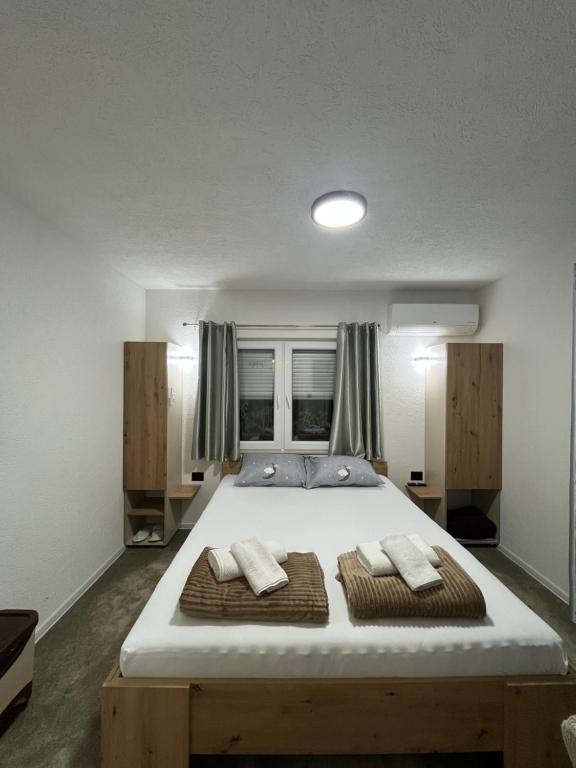 a bedroom with a large bed with two pillows at Apartments Aventra in Visoko
