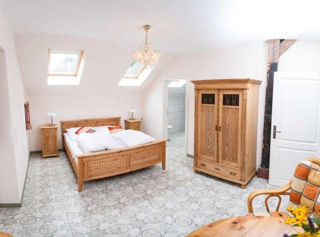 a bedroom with a bed and a wooden cabinet at Doppelzimmer Holthusen 25515 in Weener