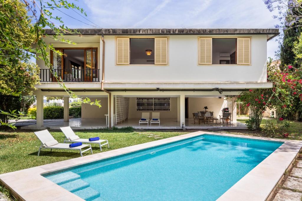 a villa with a swimming pool in front of a house at Villa Palma in Palma de Mallorca