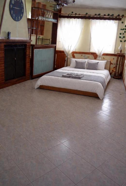 a bedroom with a bed and a clock on the wall at Home Room in San Pietro Avellana