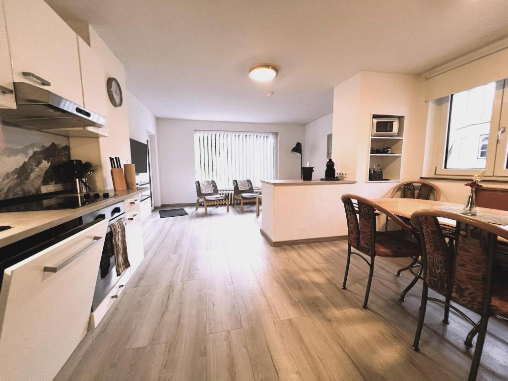 a kitchen and living room with a table and chairs at Moida-Ferienwohnung in Fügen