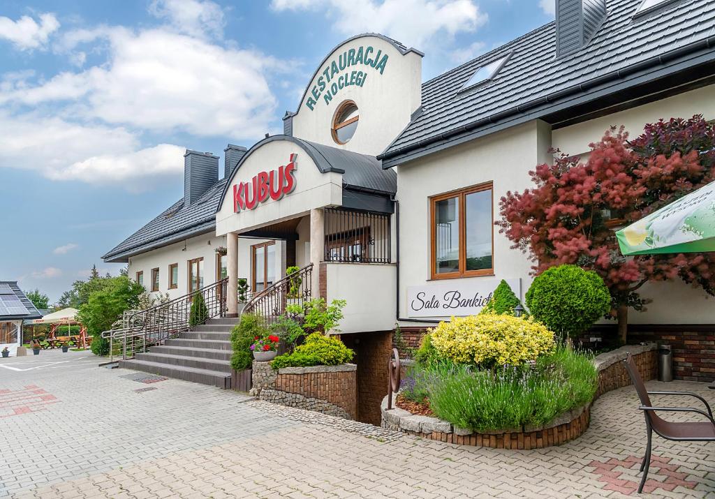 a building with a mikes sign on the side of it at Restauracja i Hotel KUBUŚ in Bełchatów