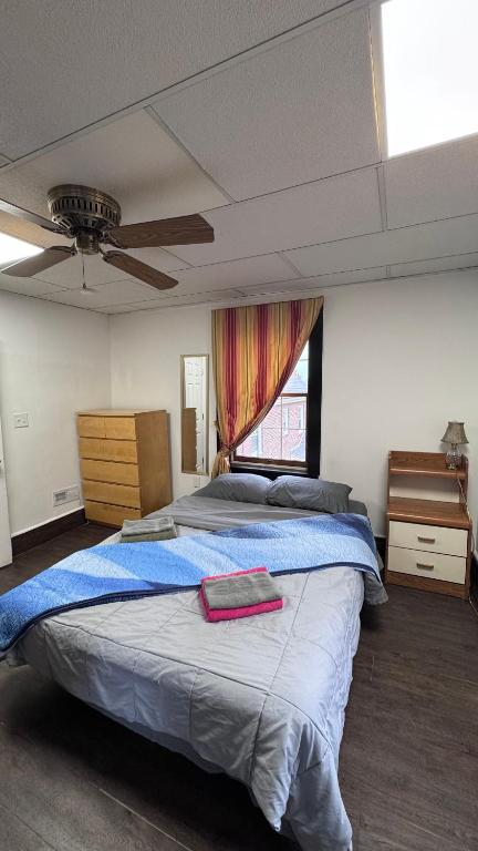 a bedroom with a large bed and a window at Private 1BR Near Boston -- Kitchen & Laundry in Malden
