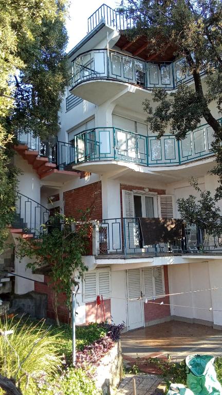 a large building with balconies on the side of it at Apartmani Primorski hrast in Bar