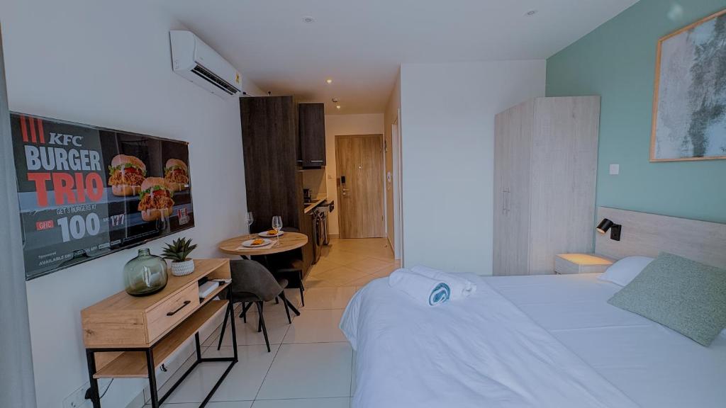a hotel room with a bed and a table and a dining room at The Loxwood House Studio in East Legon