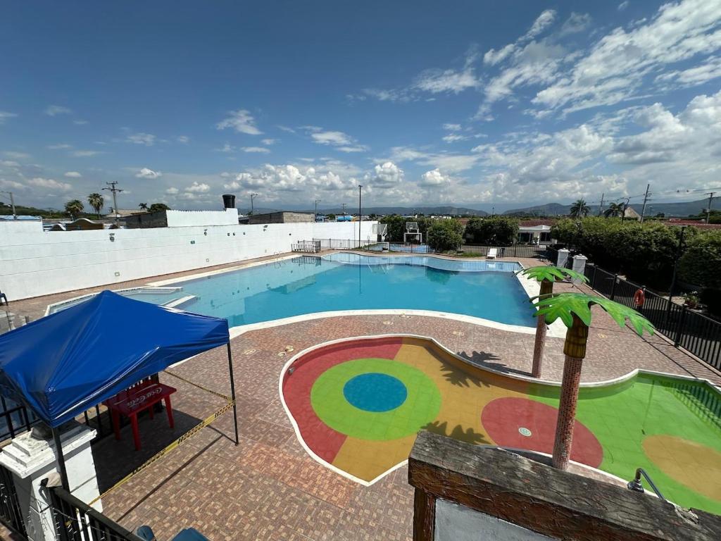 a large swimming pool with a painting on it at Casa Los Mangos 4 Piscinas 6 Camas y mucho Sol in Flandes
