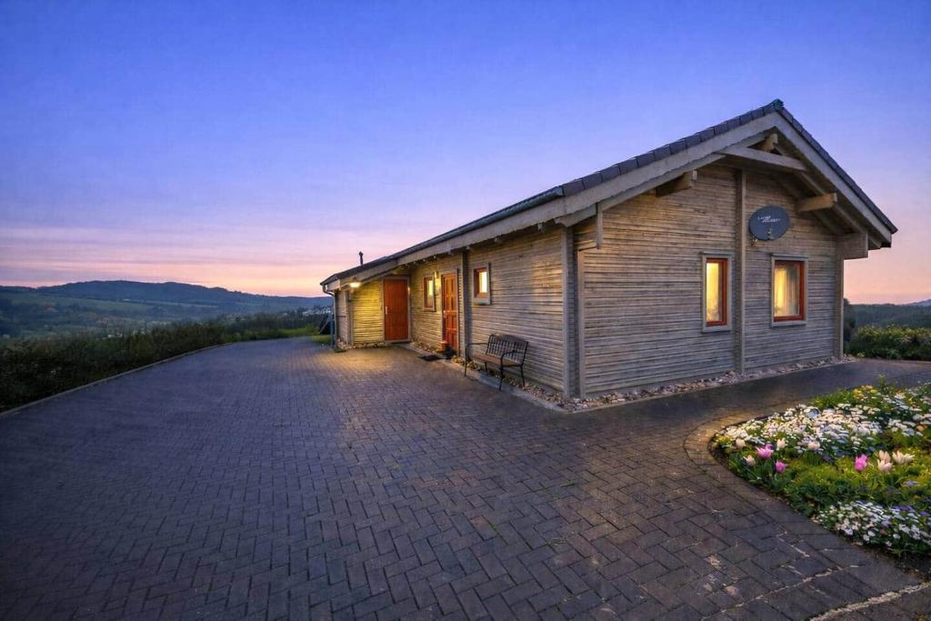 a small house with a driveway in front of it at Sky-View Chalet am Waldsee in Rieden