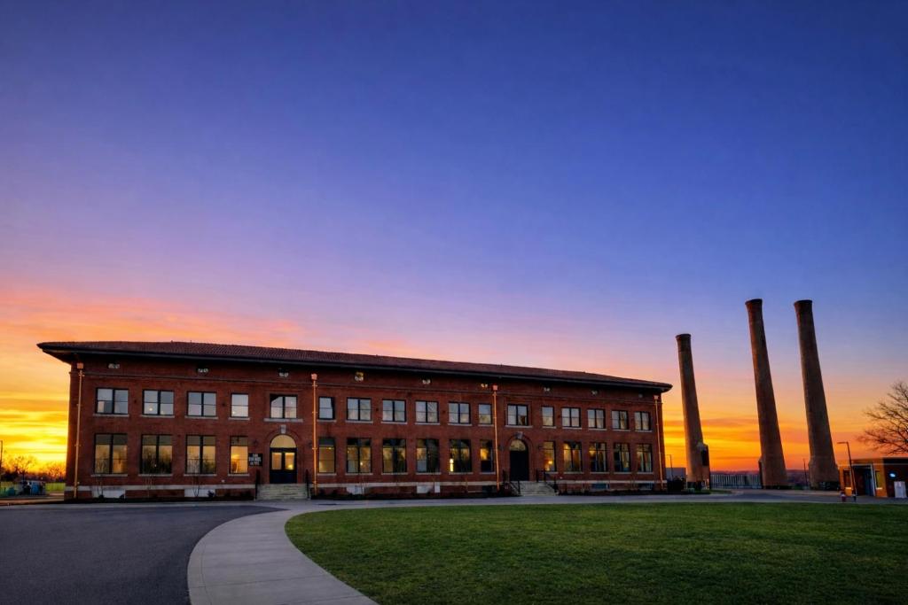 a large brick building with a sunset in the background at The Laurel Hotel in Danville