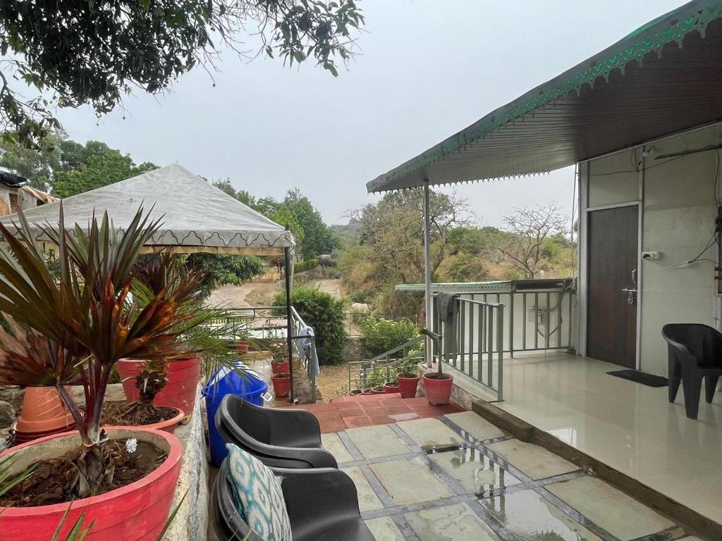 a patio with chairs and a gazebo at Amor Villa Abu in Mount Ābu