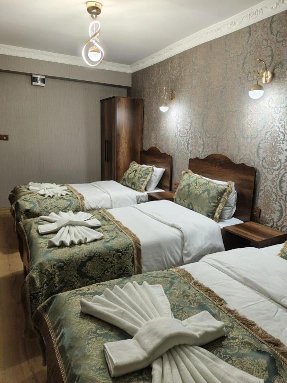 a hotel room with two beds with towels on them at Nasip House in Istanbul