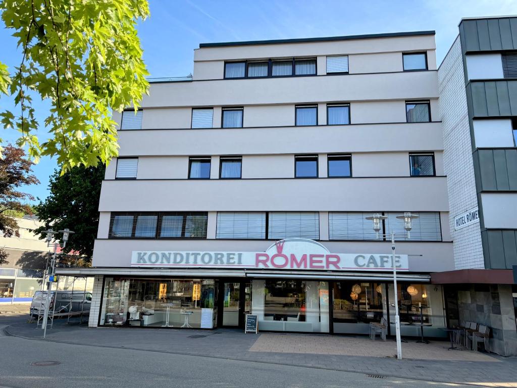 a large white building with a sign that reads anatomical ranger care at Hotel-Cafe Römer in Siegen