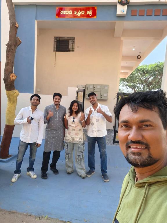 a group of people standing in front of a building at Lotus Villa Hampi in Hospet