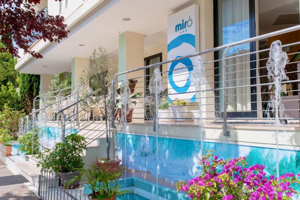 a building with flowers in front of it at Hotel MIRO' in Cattolica