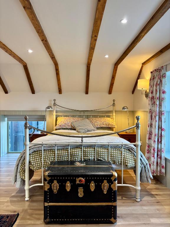 a bedroom with a bed with a trunk on it at Foyle View Glebe Barn in Tullyverry