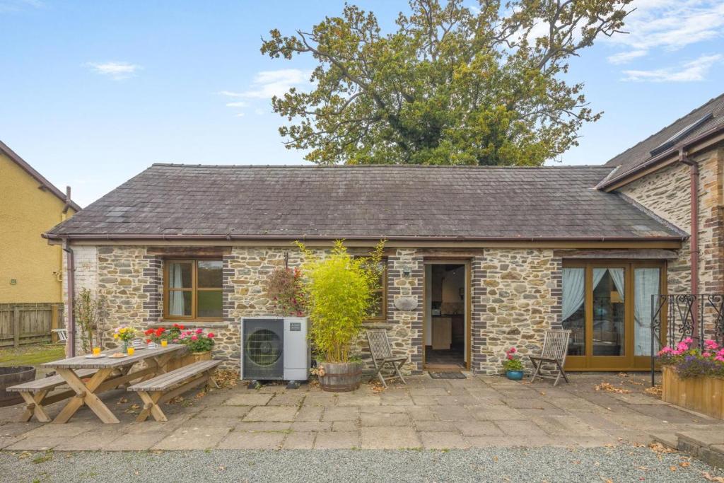 a stone cottage with a picnic table in front of it at 2 Bed in Builth Wells oc-39471 in Builth Wells