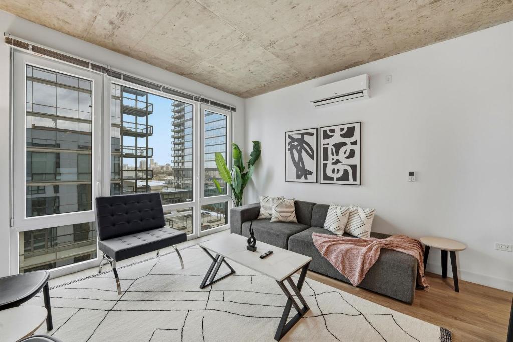 a living room with a couch and a chair at Envitae Hotel 4BR Modern Sleek Apartment in Chicago
