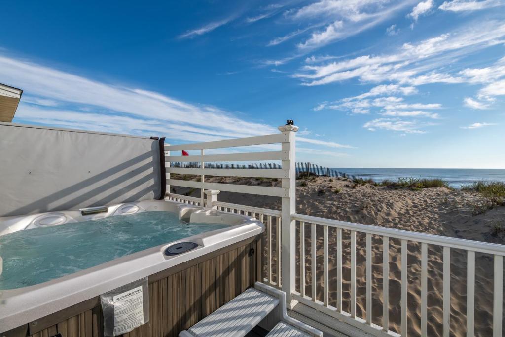 a hot tub on a balcony with the beach at Aqua Moon - Kitty Hawk MP 3, Oceanfront, Family Friendly, Hot Tub in Kitty Hawk