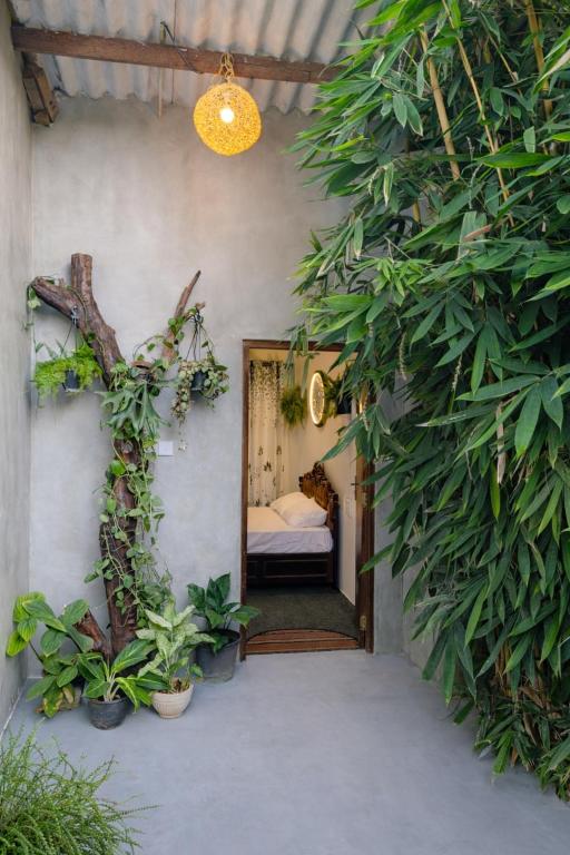 a bedroom with a bed in a room with plants at Wild Pulse Yala in Tissamaharama