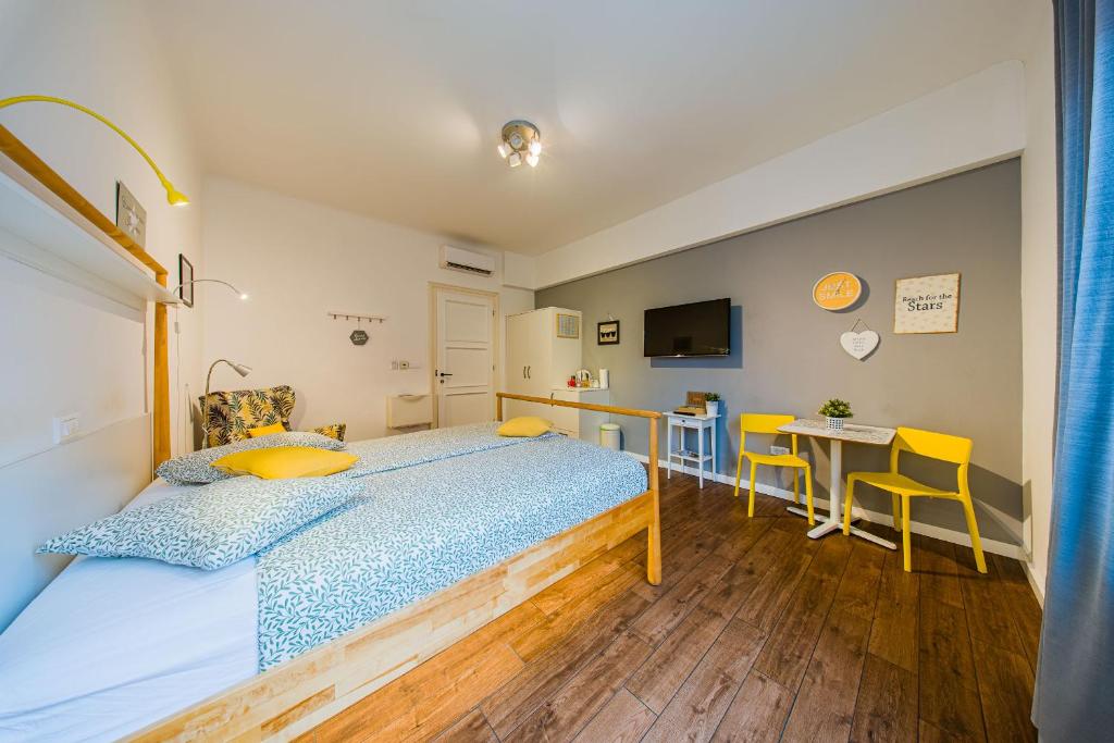 a bedroom with a bed and a table and chairs at Flex SelfCheckIns 209 - Zagreb - Studio Apartment - Centre in Zagreb