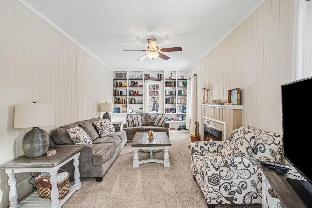 a living room with a couch and a ceiling fan at A Shore Thing in Douglas
