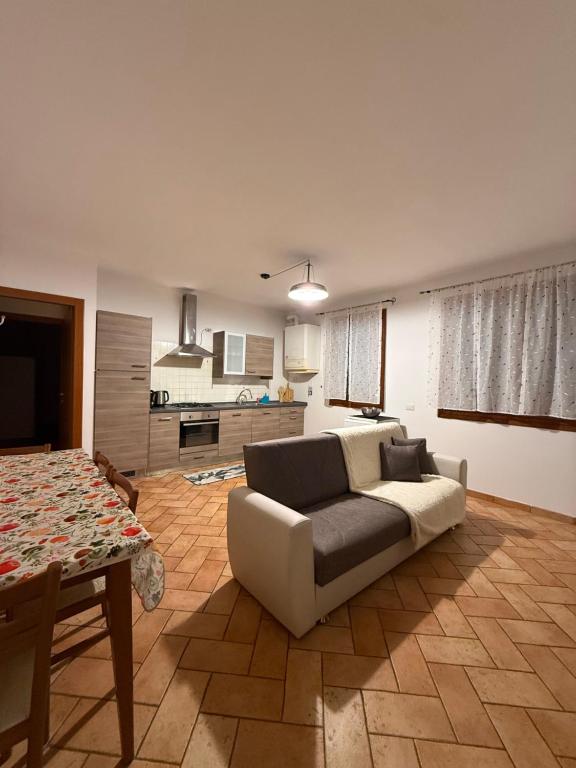 a living room with a couch and a table at ZIO CESARE FOSSO' 4 int 2 in Fossò