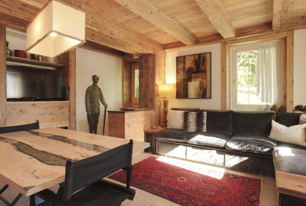 a living room with a couch and a table at Brand new beautiful ground floor flat in Cortina dʼAmpezzo