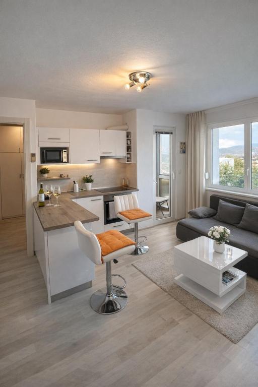 a kitchen and living room with a couch and a table at Urban Nest Nova Gorica in Nova Gorica