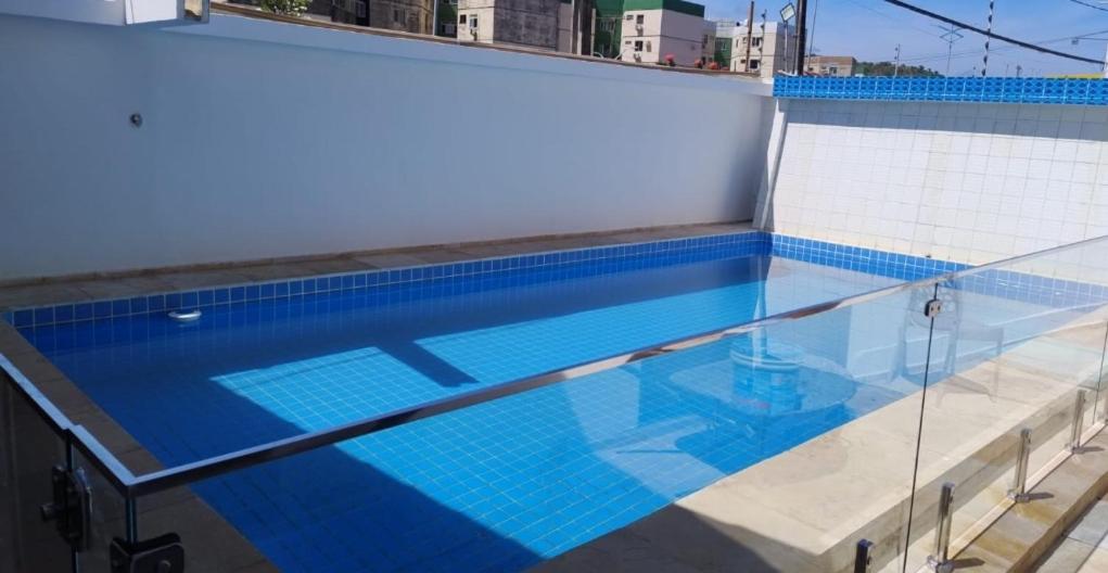 a swimming pool on top of a building at Pousada Pérola dos Corais Maceió in Maceió