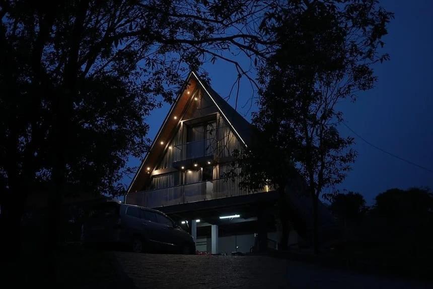 a house with lights on the side of it at night at Winter Whisper in Jāmb