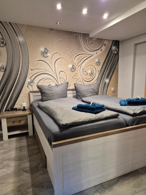 two beds in a room with a wall at Ferienwohnung Puchfrie in Bad Sooden-Allendorf