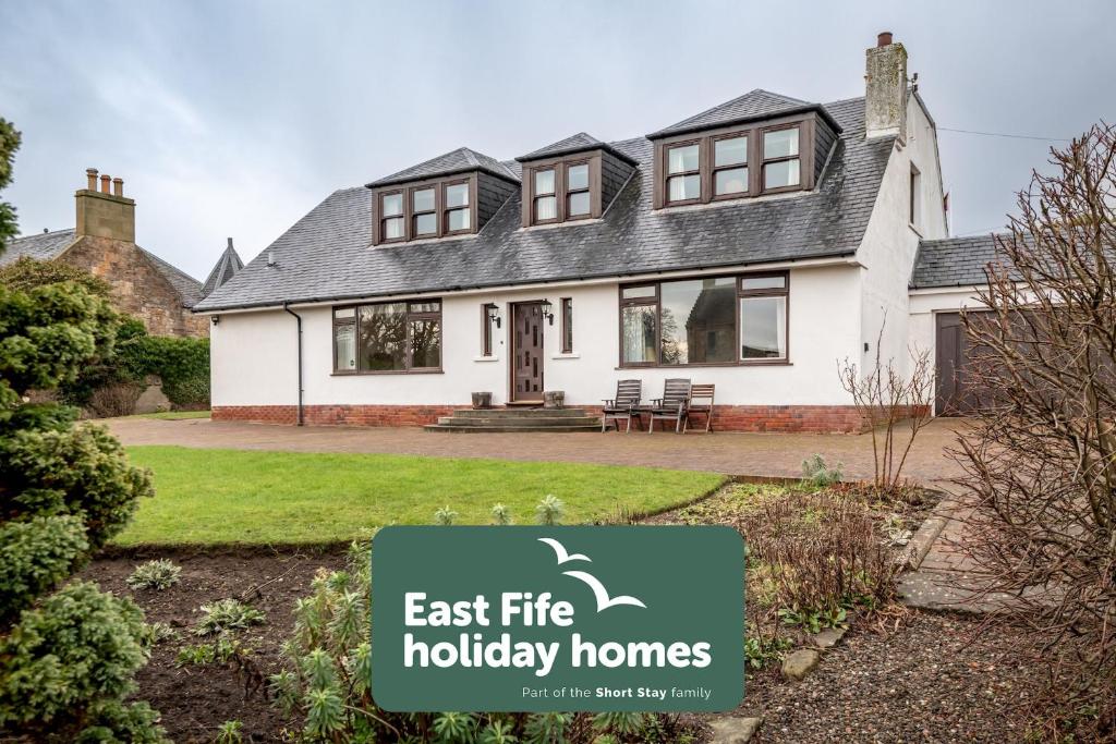 a house with a sign that reads east fire holiday homes at Melon Park - Elie in Elie