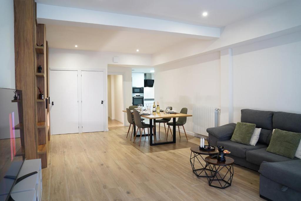 a living room with a couch and a table at Casa Dolce Casa - Elegant 3BR Apartment Near Metro & Beach,Valencia in Valencia