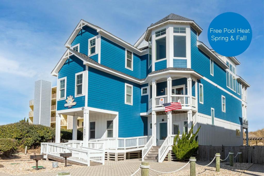 a blue house on the beach with the text free food next saving fall at Good Karma Retreat - Nags Head MP 15.5, Oceanfront, Elevator, Pool, Hot Tub, Pets OK, Flex Stays in Nags Head