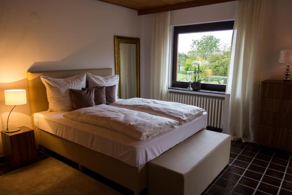 a bedroom with a large bed with a window at Domizil im Weserbergland in Dölme