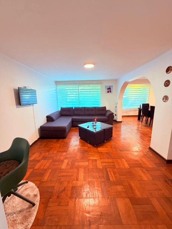 a living room with a couch and a table at Casa Las Condes, steps from Manquehue Metro in Santiago
