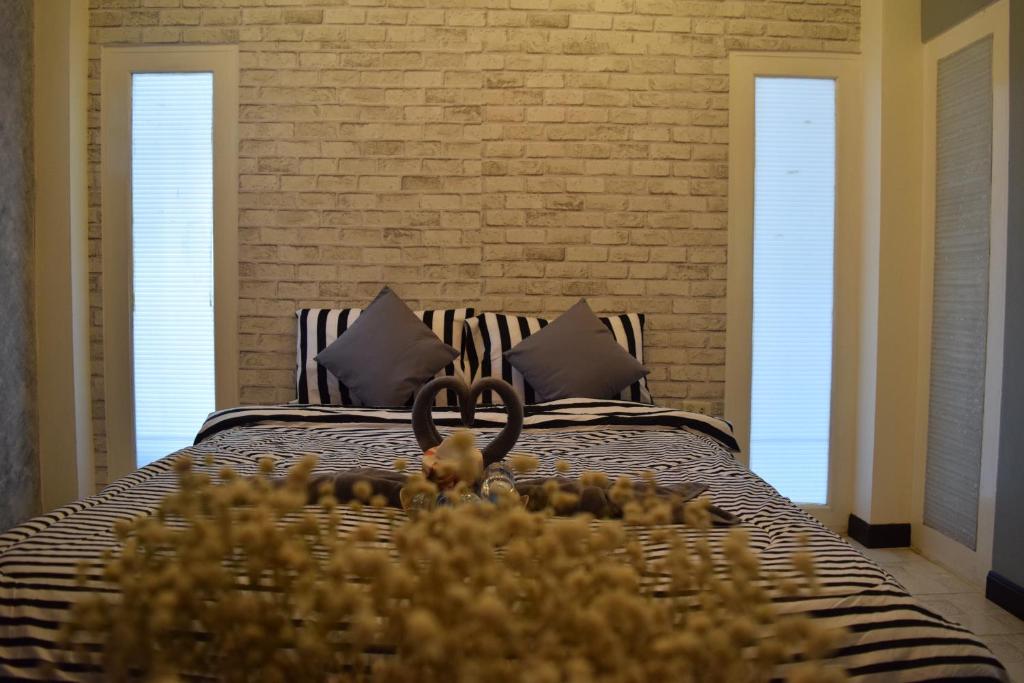 Postel nebo postele na pokoji v ubytování I-Talay Loft