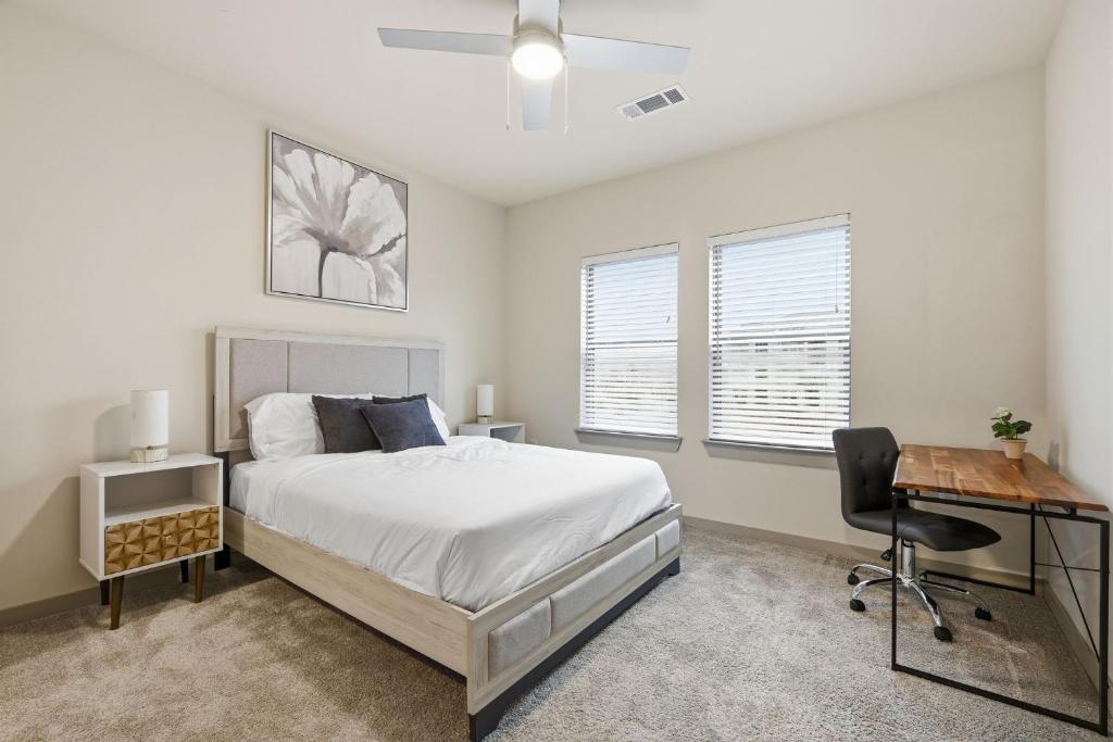 a bedroom with a bed and a desk and a chair at Chisholm Trace 1236 I Spacious 1 Bed 1 Bath in Cleburne