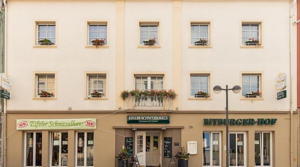 a large white building with windows and flower boxes at Hotel Bitburger Hof in Bitburg