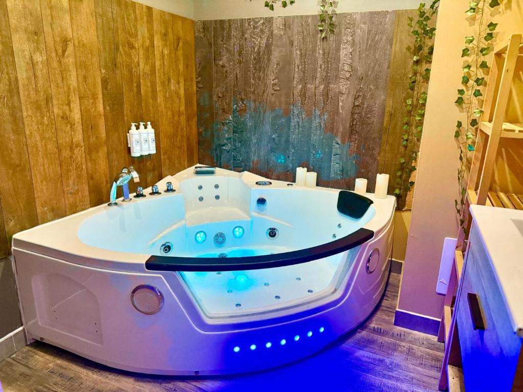 a bath tub in a bathroom with a large window at Le Jacuzzi Room in Perpignan