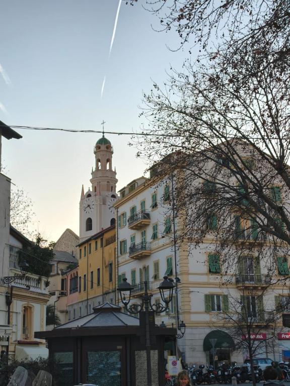 a building with a clock tower in a city at Garibaldi Apartment Sanremo La Piazzetta in Sanremo
