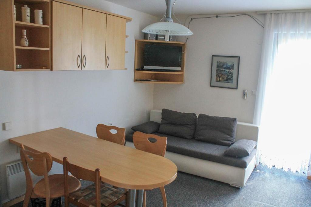 a living room with a table and a couch at Apartments Rogla in Zreče