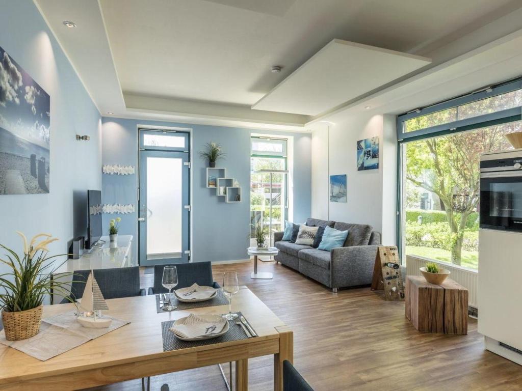a living room with a table and a couch at Strandburg "Azurblau" 01 c in Burgtiefe auf Fehmarn 