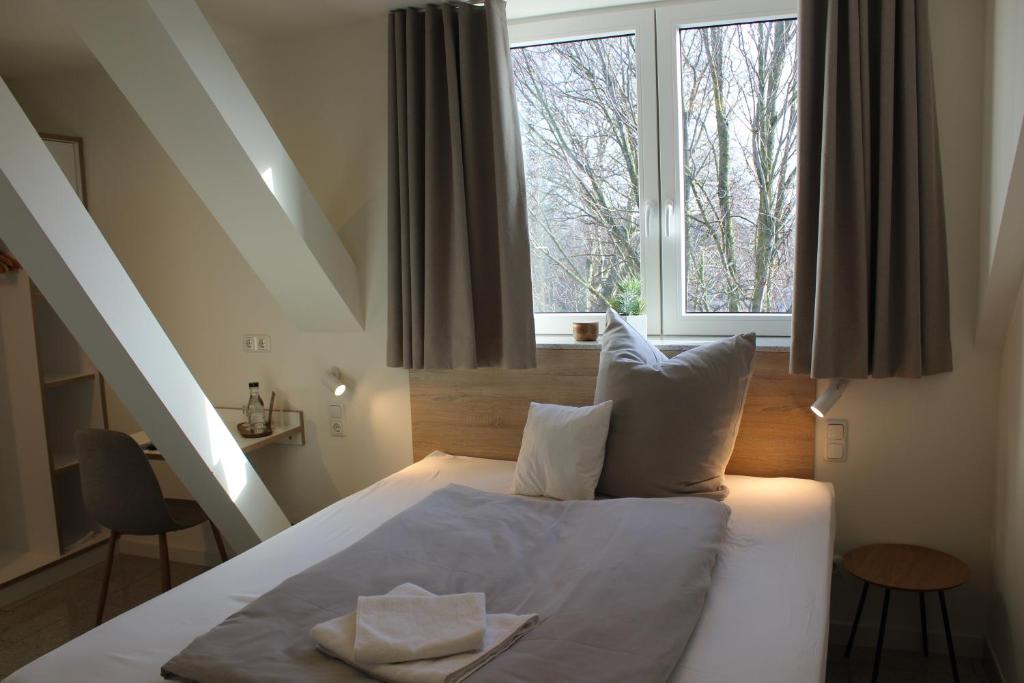 a bedroom with a bed with a large window at Schwanenhof Hotel und Restaurant in Erkelenz
