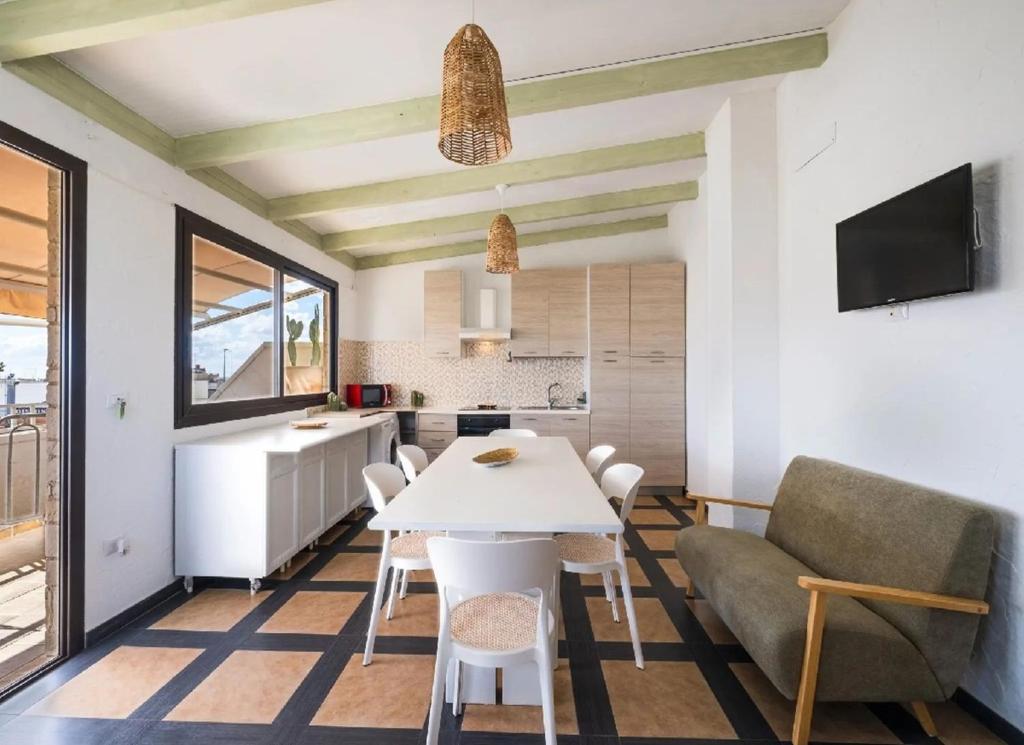 a kitchen and living room with a table and a couch at Fronte Mare in Centro a Torre Lapillo in Torre Lapillo