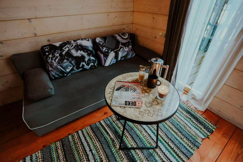 a living room with a couch and a table at Brīvdienu Māja Martz in Engure