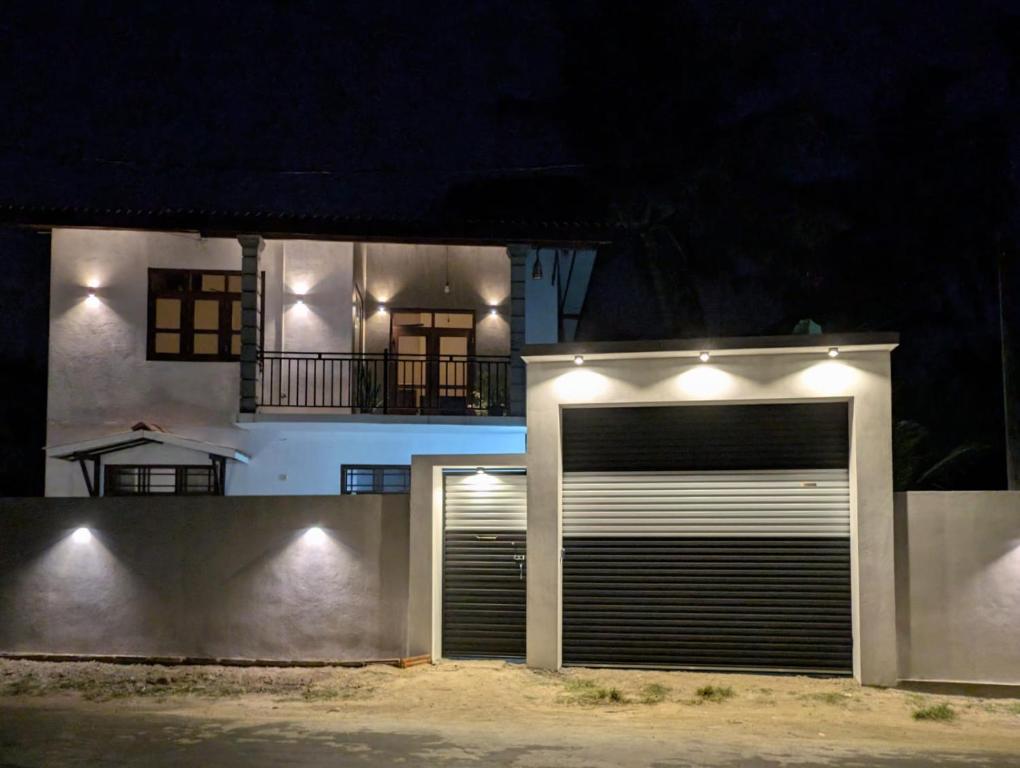 a garage door in front of a house at night at The Aurora in Ahangama