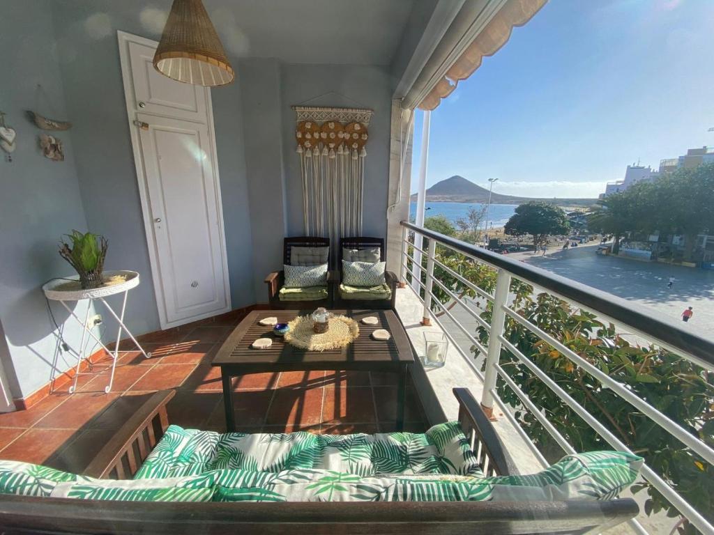 a balcony with a table and a view of the ocean at Ocean Breeze & View Médano in El Médano